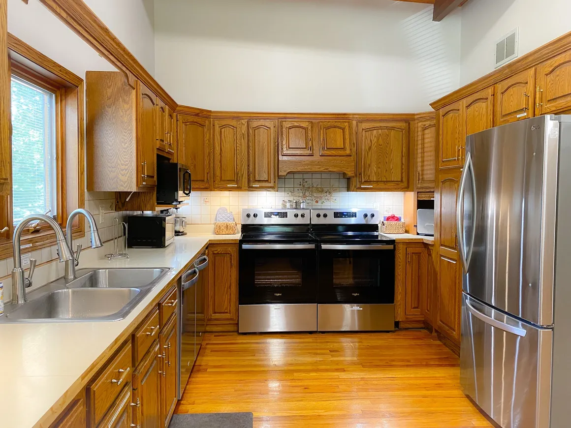 2 refrigerators, stoves, ovens, microwaves, dishwashers, and sinks.  Pantry next to fridge with additional storage in downstairs closet.
